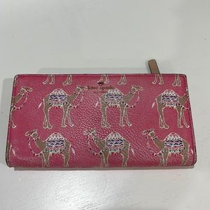 Unusual fold over wallet by Kate Spade with camels on pink background.